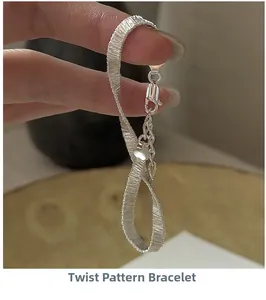 Detail of S925 silver twisted chain bracelet featuring lobster clasp and heart charm