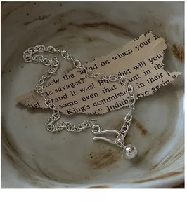 Detail shot of vintage S925 sterling silver chain bracelet with a polished bead charm