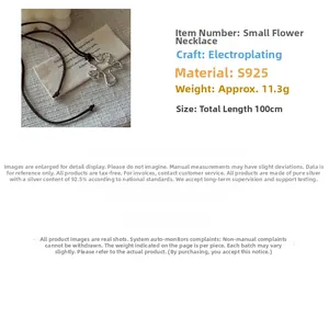 Close-up of S925 sterling silver flower pendant on a brown cord long necklace
