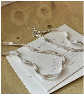 Detail of S925 sterling silver woven snake chain necklace with lobster clasp closure