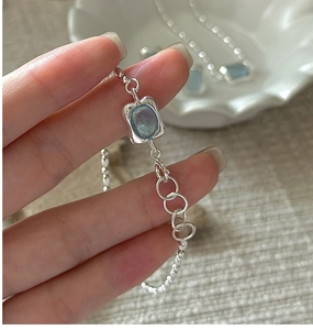 Detail of S925 silver bracelet with light blue aquamarine gemstone and adjustable chain