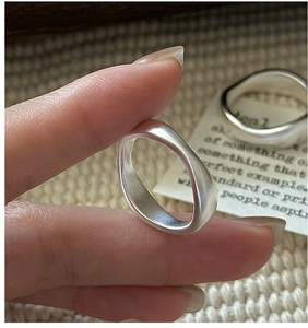 Macro shot of S925 sterling silver rings with irregular wavy design and matte finish