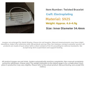 Detailed view of S925 sterling silver twisted open bangle on a rustic fabric background