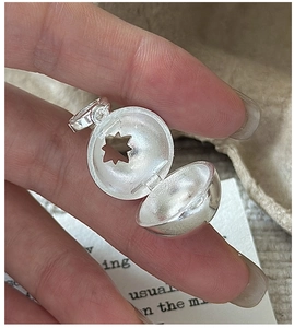 Macro view of S925 sterling silver sphere pendant with star cutout and hinged opening