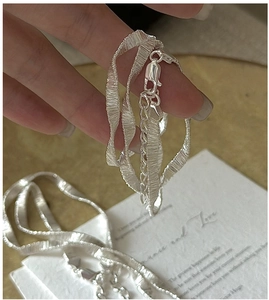 Detailed view of S925 sterling silver chain with unique ruffled silk-like texture design