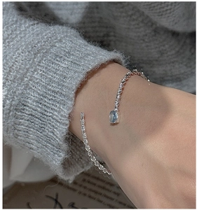 Close-up of S925 sterling silver open bracelet with rope texture and light blue gemstone