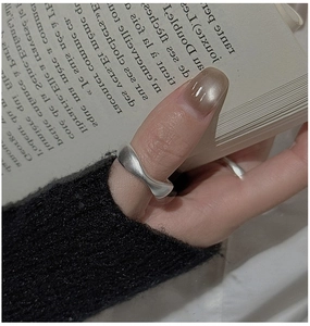 Macro shot of minimalist S925 sterling silver ring with matte wavy textured surface