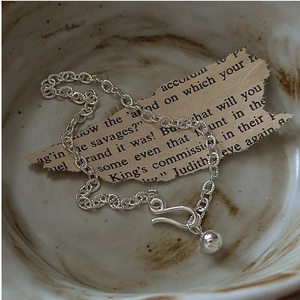 Detailed macro view of S925 sterling silver chain bracelet with S-hook clasp and bead