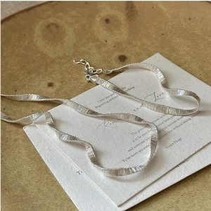 Detailed close-up of S925 sterling silver chain with satin finish and lobster clasp