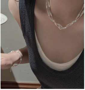 Detailed close-up of S925 sterling silver necklace with unique twisted texture on skin