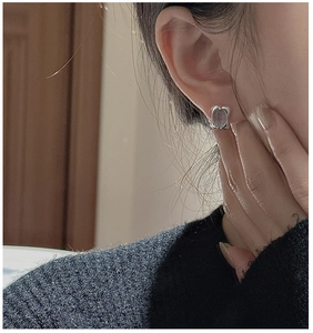 Close-up of minimalist rectangular S925 silver earrings with translucent aquamarine stone