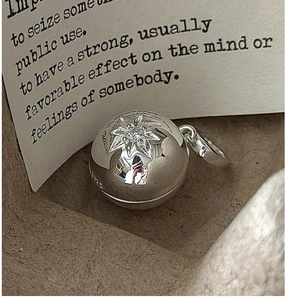 Detail of S925 sterling silver ball pendant with engraved star and cubic zirconia stone