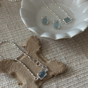 Minimalist S925 silver jewelry set featuring oval aquamarine necklace and stud earrings
