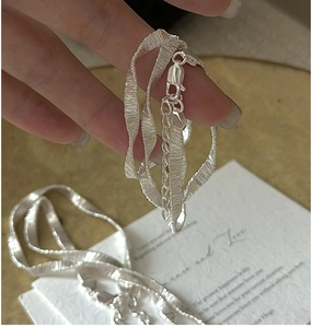 Detail of S925 sterling silver chain with wavy texture and lobster clasp closure