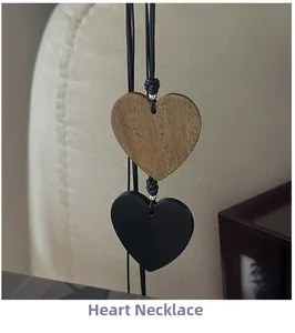 Macro shot of minimalist wooden and black matte heart pendants on cord necklaces