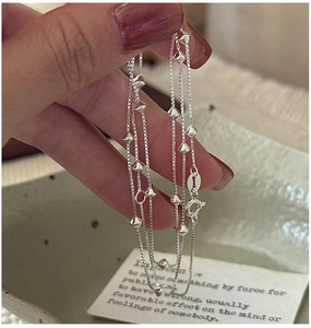Close-up of S925 sterling silver box chain necklace with delicate conical beads
