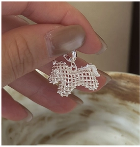 Detailed macro view of S925 sterling silver hollow mesh horse pendant with round clasp