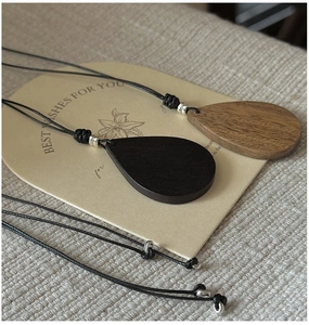 Detailed close-up of water drop wooden pendants showing natural grain and silver beads