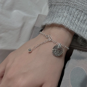 S925 sterling silver chain bracelet with a textured round charm and hook clasp