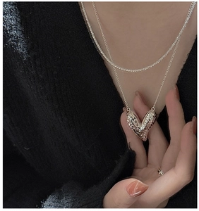 Detail view of double-layer S925 silver necklace with textured 3D heart pendant
