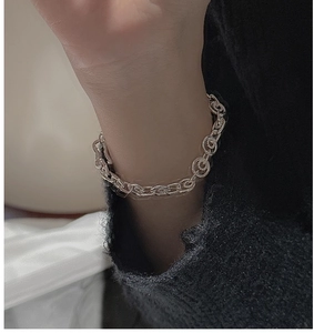 Detailed close-up of S925 sterling silver chunky chain bracelet on woman wrist