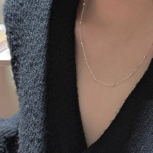 Minimalist S925 sterling silver box chain necklace with faceted beads on a model