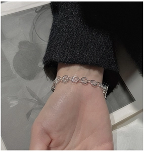 Detail of S925 sterling silver chain bracelet featuring textured spiral links on wrist