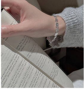 Close-up of minimalist S925 silver bracelet featuring polished square and oval links