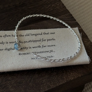 Minimalist S925 sterling silver open bangle with light blue gemstone and twisted rope design