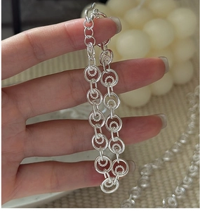 Detail view of S925 sterling silver chain bracelet with textured double ring links