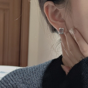 Elegant S925 sterling silver earrings featuring a translucent light purple gemstone on a model