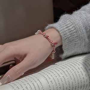 S925 sterling silver red woven rope bracelet with vintage nomadic beads on a gray sweater