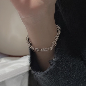 Modern S925 sterling silver chain bracelet with textured round links on a female wrist