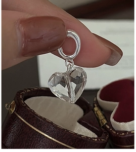 Close-up of S925 silver hoop earring with multifaceted clear heart crystal pendant