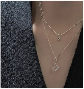 Detail of S925 silver double-layered necklace with heart crystal and teardrop pendant
