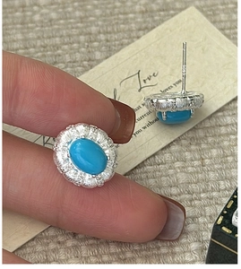 Detail of S925 sterling silver turquoise earrings with petal relief and hallmark engraving