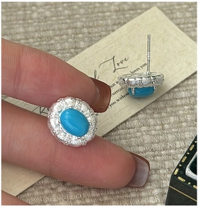 Macro detail of S925 sterling silver turquoise earrings with hand-forged texture