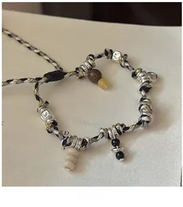 Detailed close-up of S925 sterling silver beads on a multi-color braided rope bracelet
