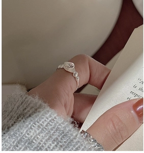 Close-up of S925 sterling silver shell pearl ring with textured band worn on finger
