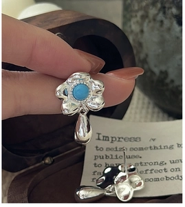 Close-up of S925 sterling silver flower earrings with turquoise stones and teardrop detail