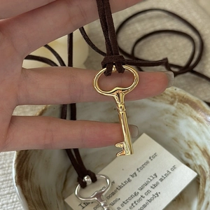 Vintage key pendant necklace with polished metal and brown velvet cord for women