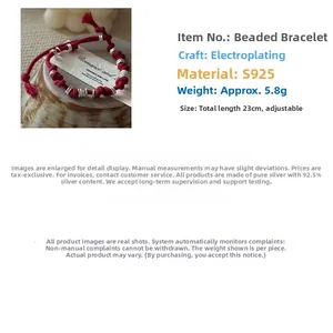 Detailed view of adjustable S925 sterling silver beads on a red braided rope bracelet