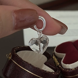 S925 sterling silver heart-shaped faceted crystal pendant held against a velvet box