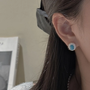 Vintage S925 sterling silver turquoise stud earrings with micro-pave crystals on a model