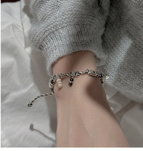 Macro detail of retro S925 silver braided bracelet with black and white bead accents