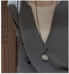 Detail of S925 sterling silver elephant pendant necklace with a dark braided cord