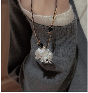 Detailed close-up of a brushed S925 silver mother and baby elephant pendant necklace