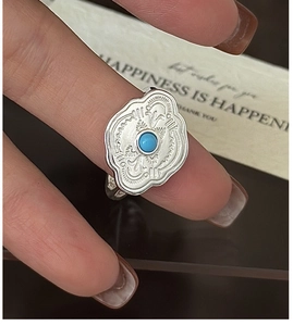 Detail of S925 sterling silver turquoise ring with retro embossed patterns and vintage finish