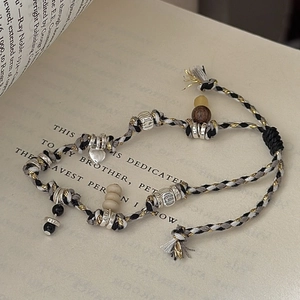 Retro S925 sterling silver woven bracelet with heart charm and wood beads on vintage book