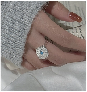 Macro shot of S925 silver vintage ring with turquoise stone and ethnic carvings